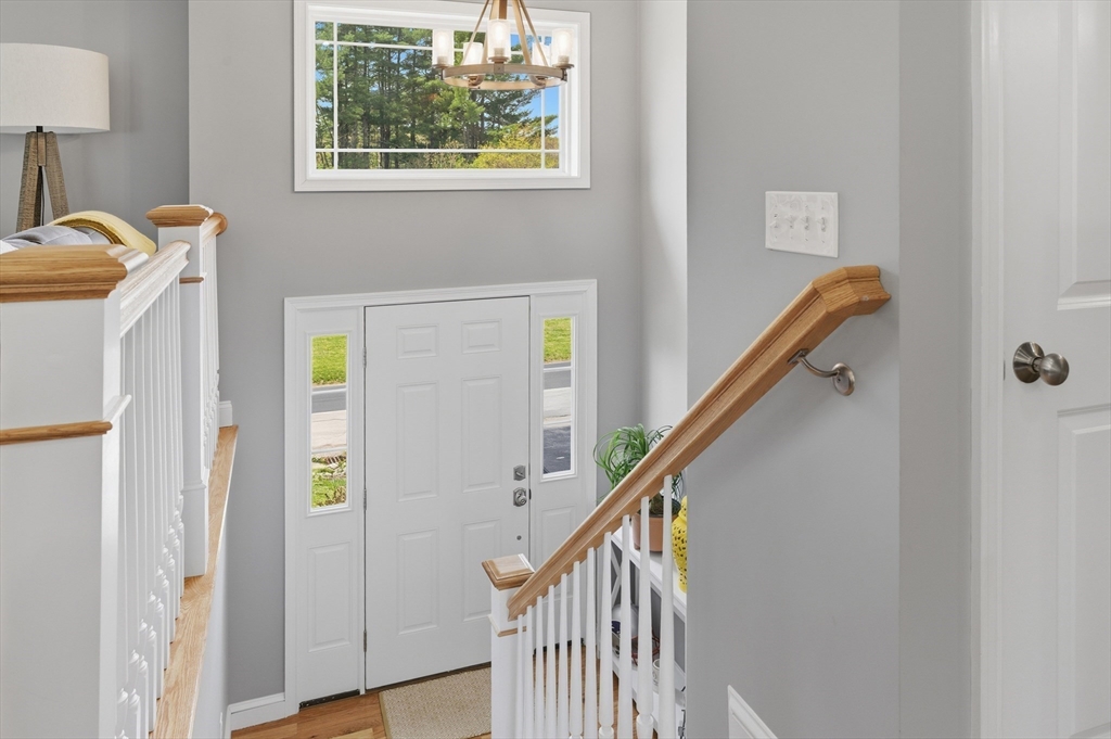 19 Progress Avenue Dudley, MA 01571 - Photo 12 of 42 a view of hallway with stairs and wooden floor