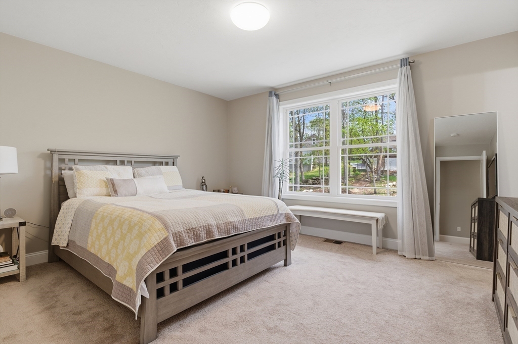 19 Progress Avenue Dudley, MA 01571 - Photo 13 of 42 a bed sitting in a bedroom next to a window