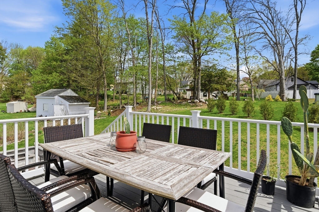 19 Progress Avenue Dudley, MA 01571 - Photo 27 of 42 a view of a balcony with table and chairs and wooden floor