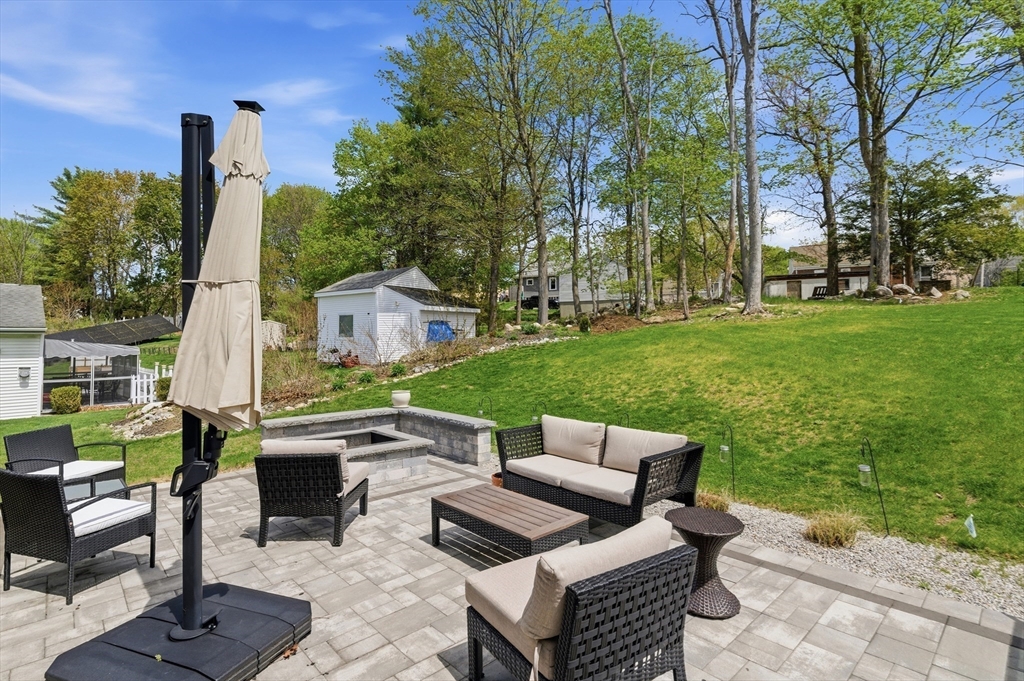 19 Progress Avenue Dudley, MA 01571 - Photo 33 of 42 a backyard of a house with table and chairs