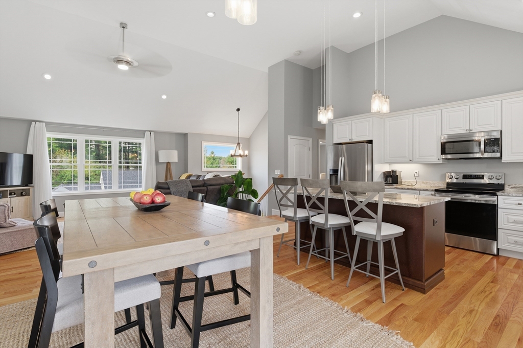 19 Progress Avenue Dudley, MA 01571 - Photo 7 of 42 a kitchen with stainless steel appliances a dining table chairs and wooden floor