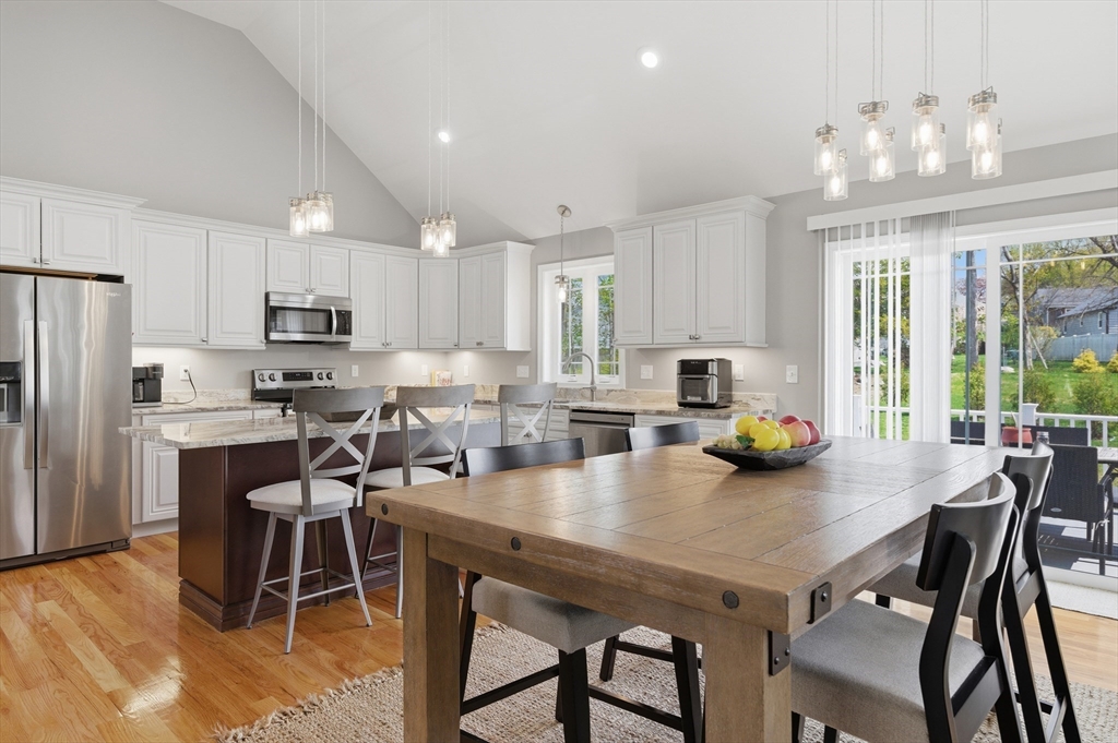 19 Progress Avenue Dudley, MA 01571 - Photo 8 of 42 a kitchen with a dining table chairs and refrigerator