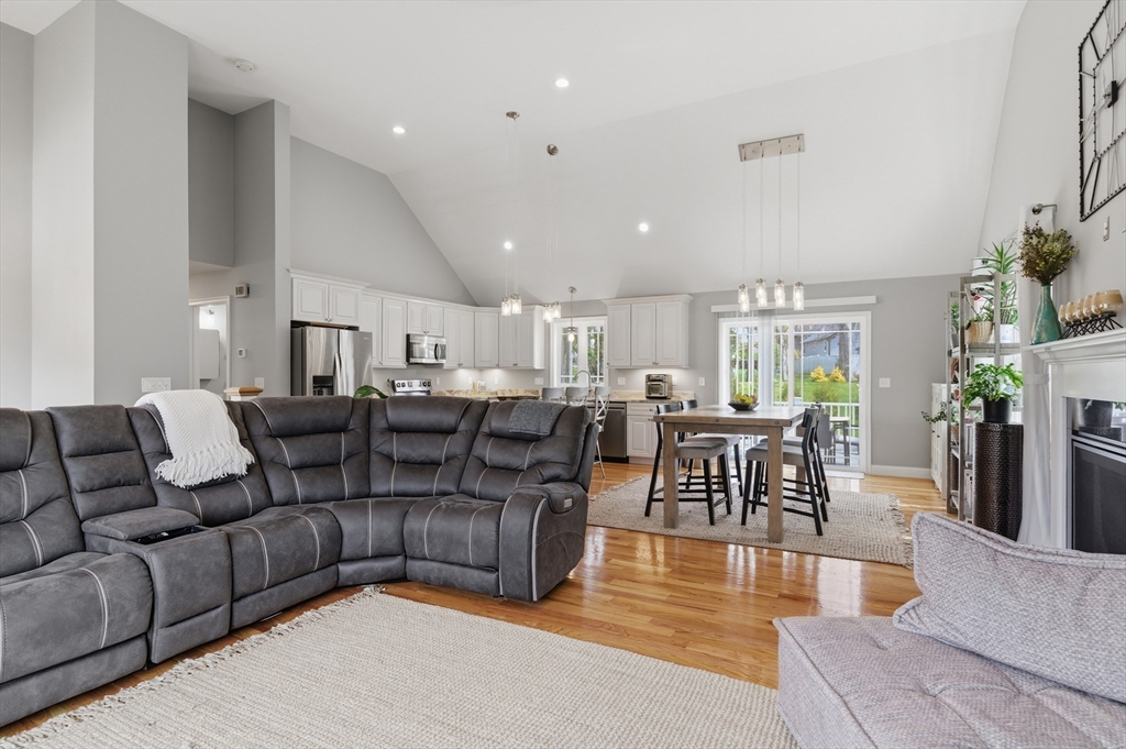 19 Progress Avenue Dudley, MA 01571 - Photo 9 of 42 a living room with furniture wooden floor and a view of kitchen