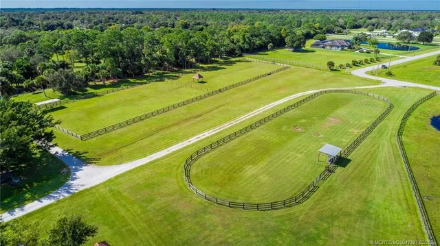 a spacious bedroom with a bed and glass windows