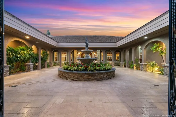a view of a house with fountain bath tub and fire pit