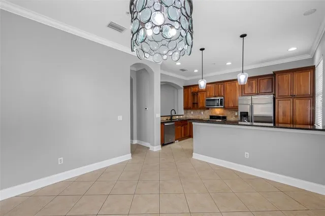 a kitchen with stainless steel appliances granite countertop a stove top oven a sink and dishwasher