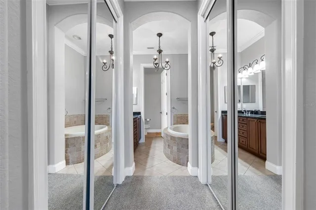a spacious bathroom with a granite countertop tub sink and mirror