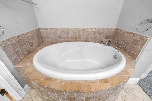 a bathroom with a tub and a shower