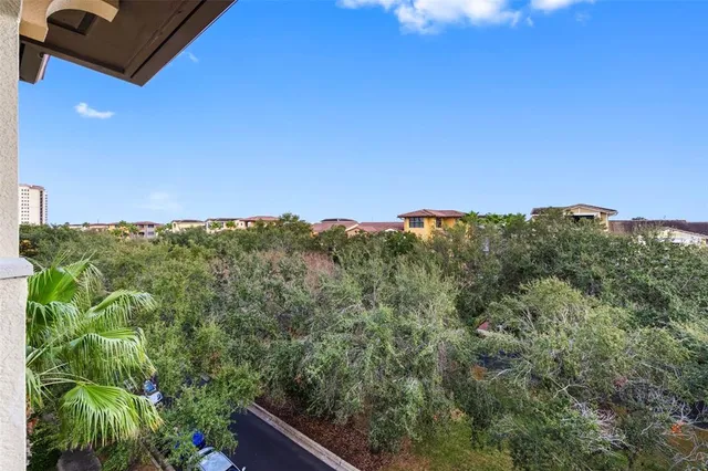 a front view of a multi story residential apartment building with yard and green space