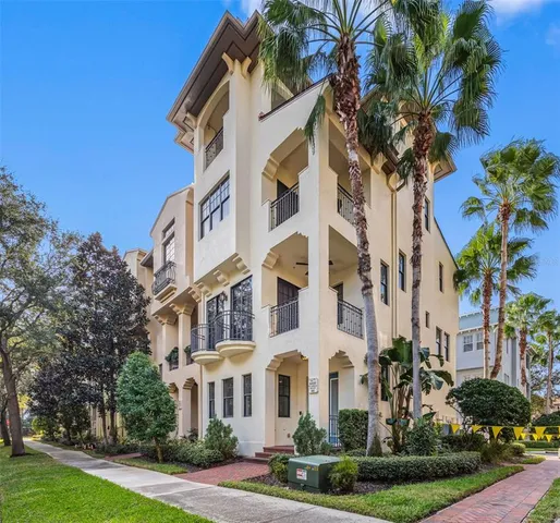 a view of a house with a yard and potted plants