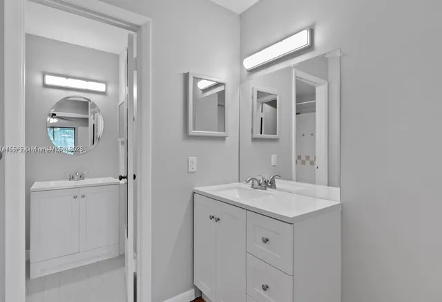a bathroom with a sink a light fixture a vanity and a mirror