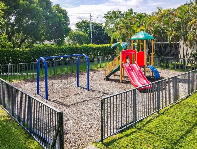 a view of park with swings and slides