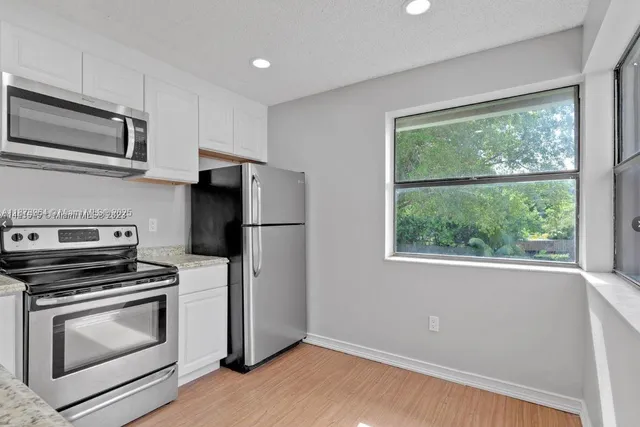 a kitchen with a refrigerator stove and microwave
