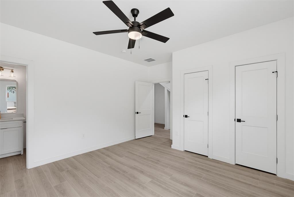 512 South O Connor Road Irving, TX 75060 - Photo 6 of 21 Interior room with light wood-finish flooring and white walls