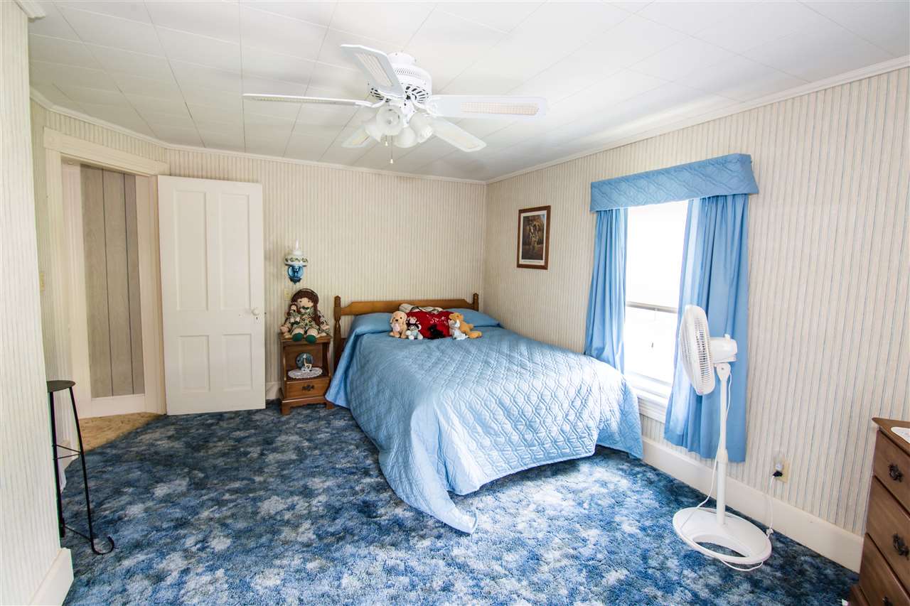 5565 Briery Branch Road Dayton, VA 22821 - Photo 12 of 26 a bedroom with a bed and a window