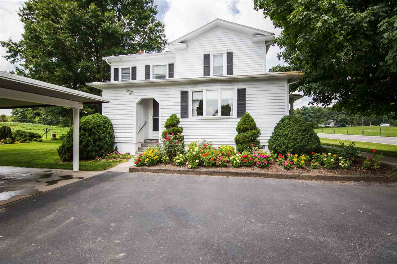5565 Briery Branch Road Dayton, VA 22821 - Photo 20 of 26 a front view of a house with a yard and potted plants