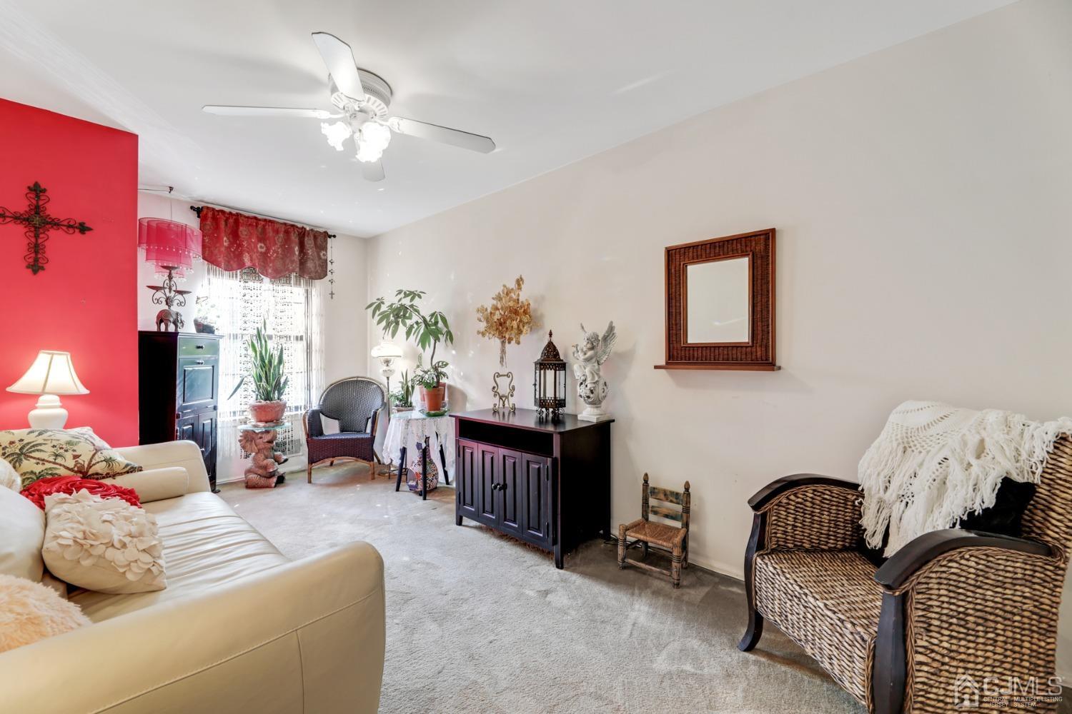 81 Pheasant Run Edison, NJ 08820 - Photo 14 of 24 a living room with furniture and a chandelier