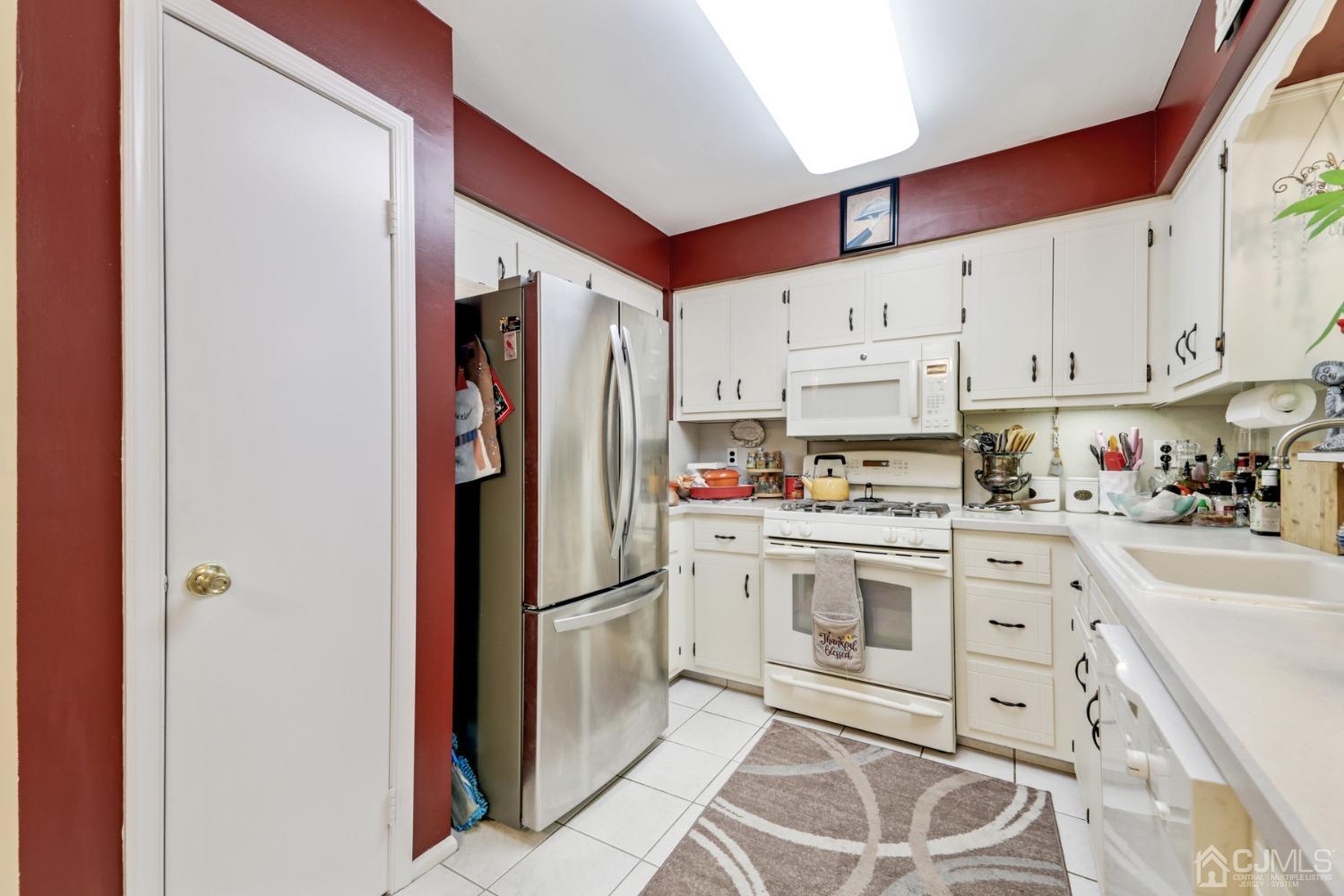 81 Pheasant Run Edison, NJ 08820 - Photo 8 of 24 a kitchen with stainless steel appliances granite countertop a refrigerator sink and white cabinets