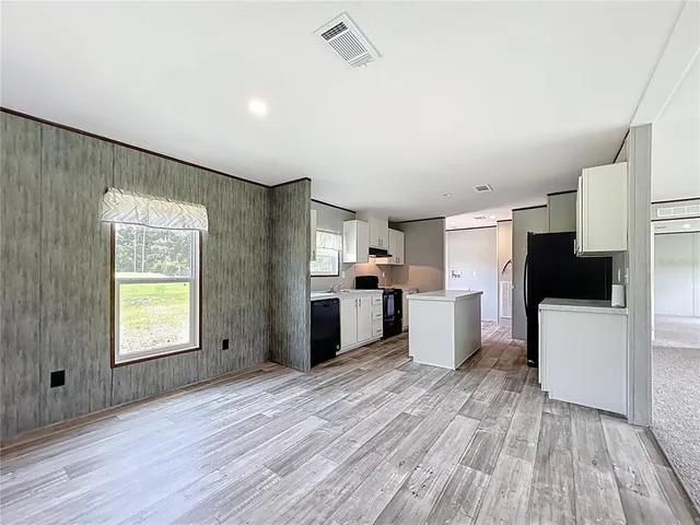 a kitchen view with granite countertop a refrigerator and a stove