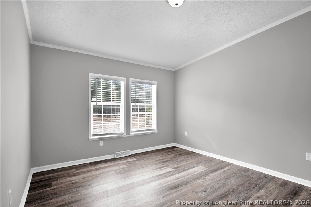 143 South Cherry St Extension Pinebluff, NC 28373 - Photo 13 of 25 an empty room with wooden floor and windows