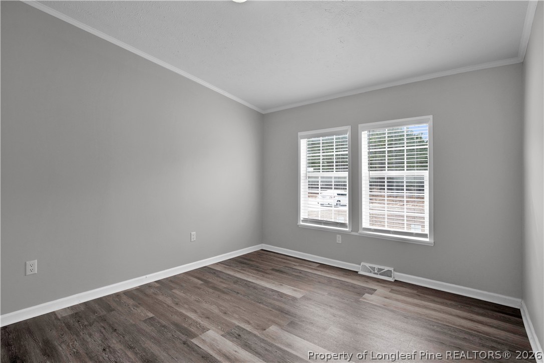 143 South Cherry St Extension Pinebluff, NC 28373 - Photo 15 of 25 a view of an empty room with wooden floor and a window