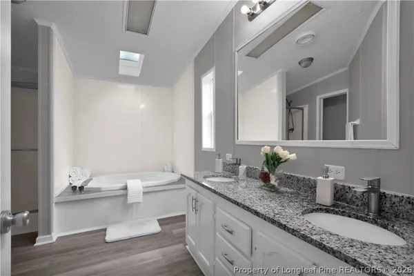 a bathroom with a tub and a shower