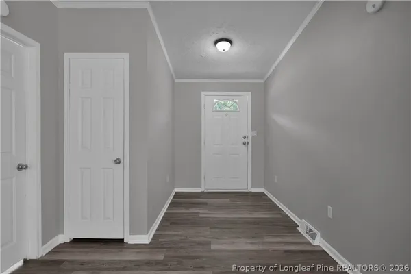 a view of a hallway with wooden floor