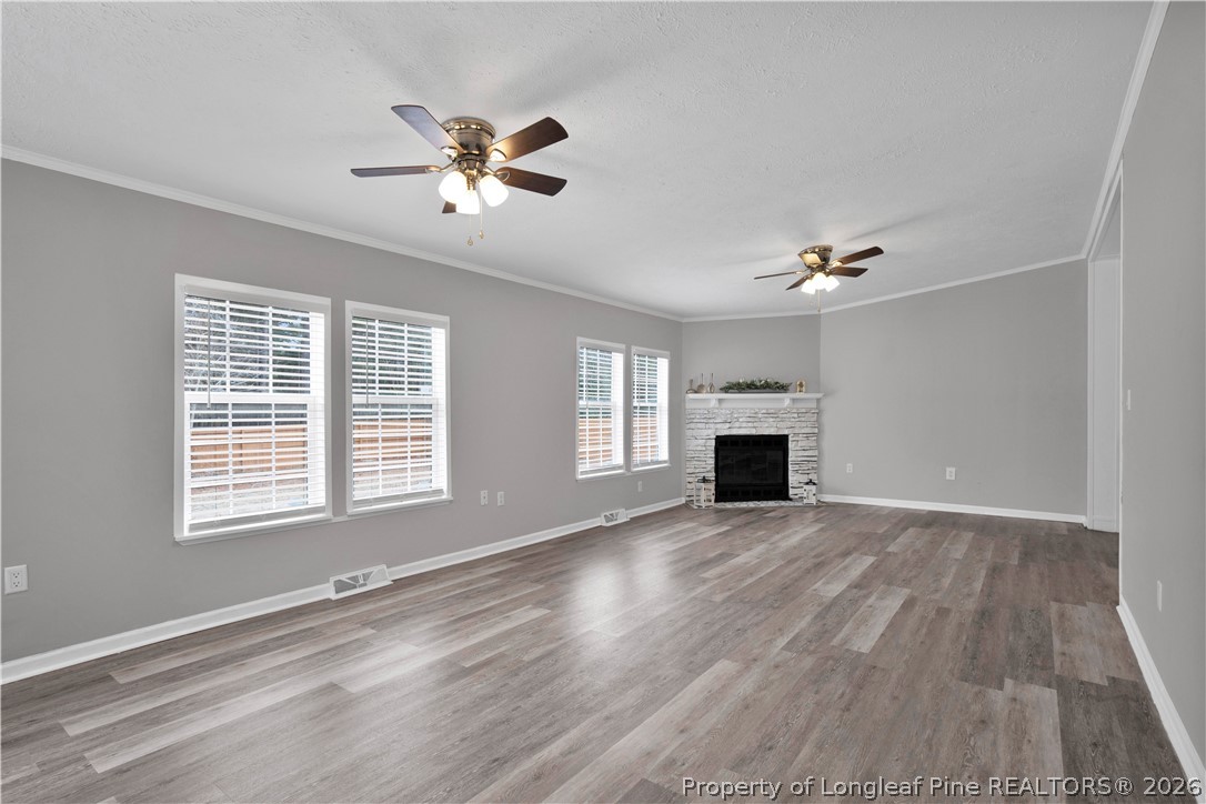 143 South Cherry St Extension Pinebluff, NC 28373 - Photo 4 of 25 a view of an empty room with wooden floor and a window