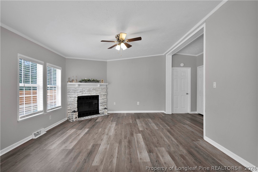 143 South Cherry St Extension Pinebluff, NC 28373 - Photo 5 of 25 a view of an empty room with a fireplace and a window