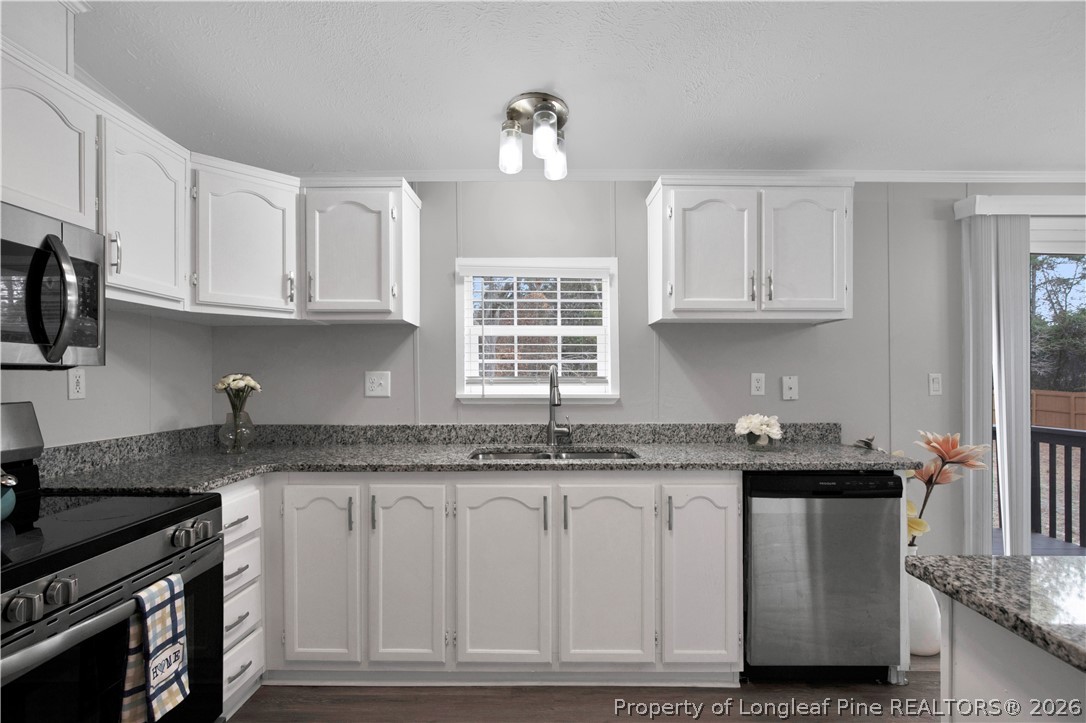 143 South Cherry St Extension Pinebluff, NC 28373 - Photo 10 of 25 a kitchen with granite countertop a sink stove and cabinets