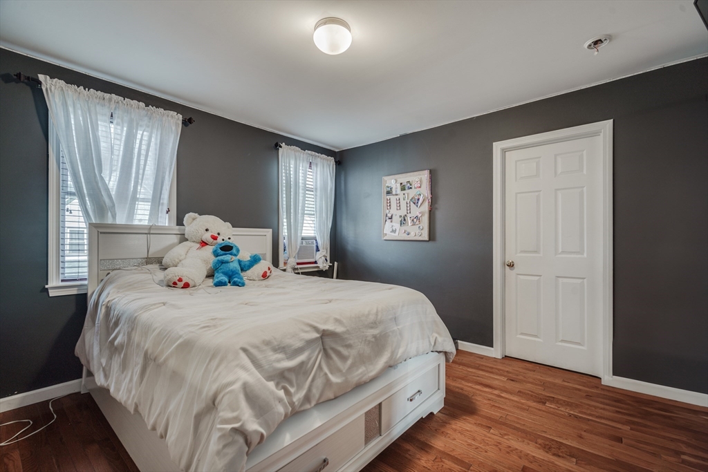 18 Chester Street Springfield, MA 01105 - Photo 20 of 41 a bedroom with a bed and wooden floor
