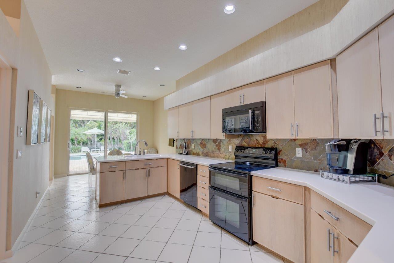 5758 Northwest 24th Terrace Boca Raton, FL 33496 - Photo 17 of 35 a kitchen with a sink and white cabinets