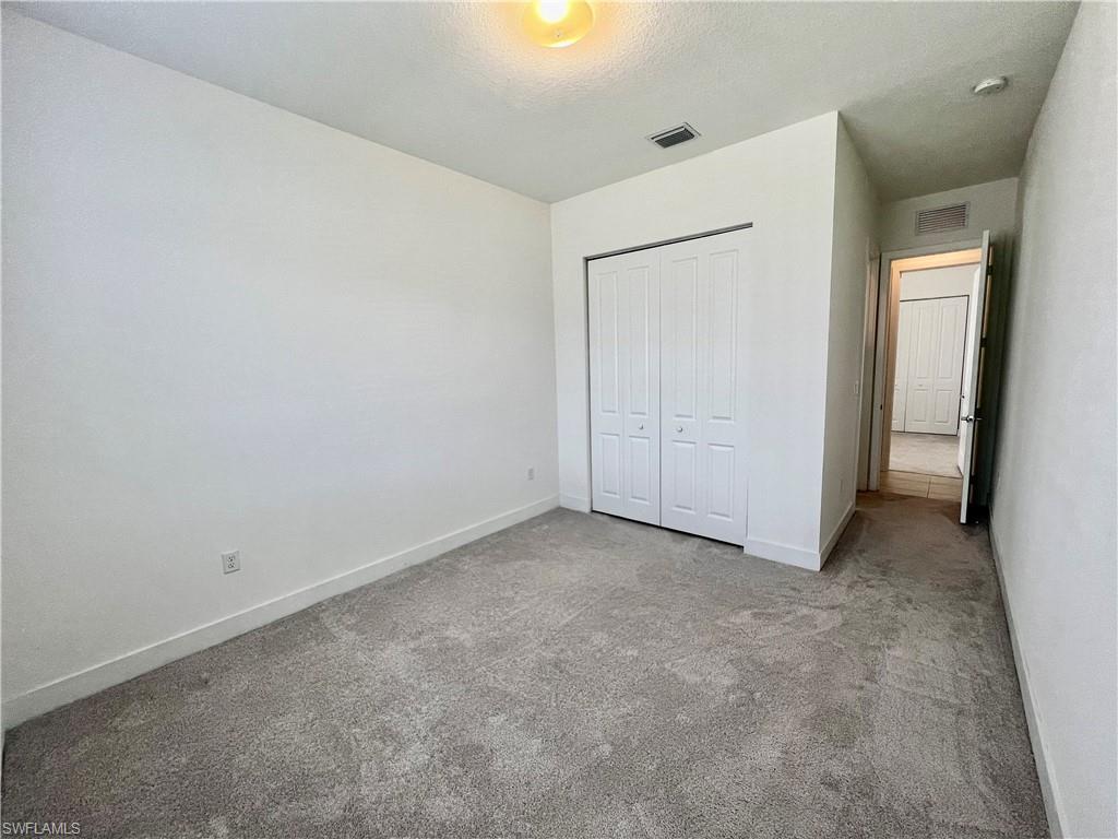 5015 Frattina St Avenue Immokalee, FL 34142 - Photo 10 of 23 an empty room with closet and mirror