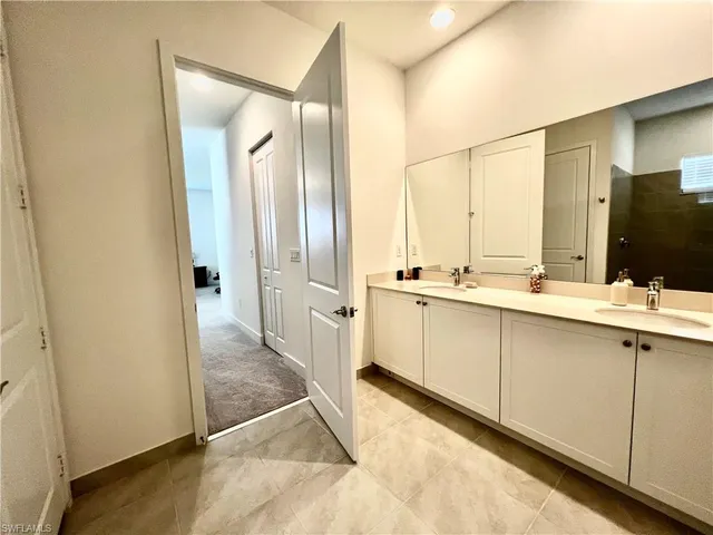 an empty room with closet and mirror