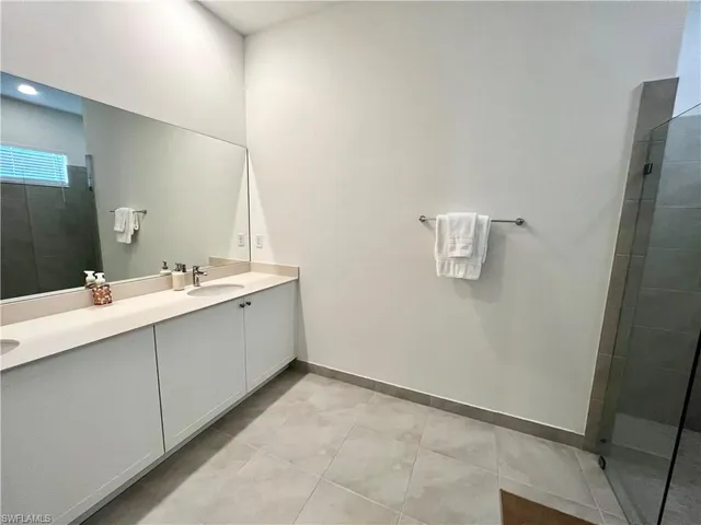 a bathroom with a double vanity sink and mirror