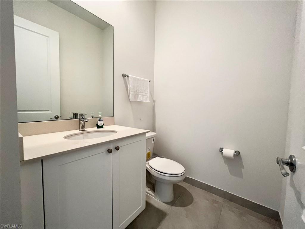 5015 Frattina St Avenue Immokalee, FL 34142 - Photo 16 of 23 a bathroom with a sink mirror vanity and toilet