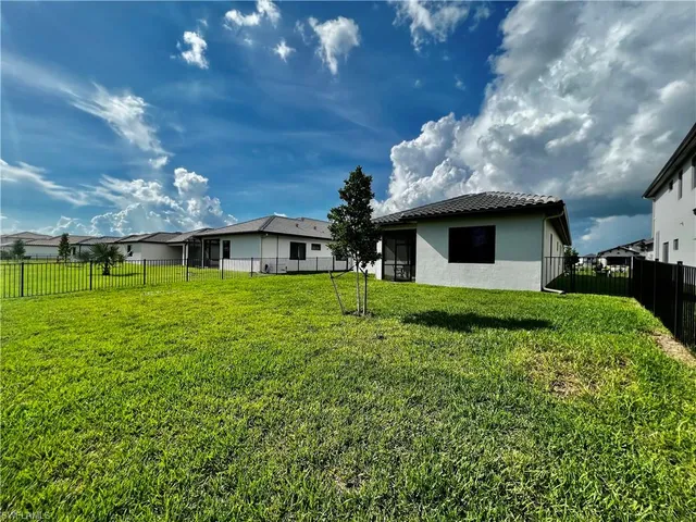 a front view of house with a garden