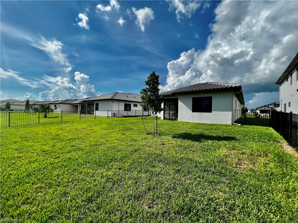 5015 Frattina St Avenue Immokalee, FL 34142 - Photo 20 of 23 a front view of house with a garden
