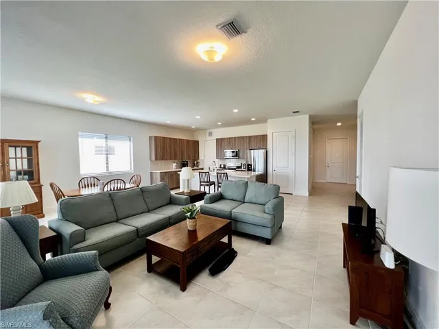 a kitchen with stainless steel appliances a refrigerator and a stove top oven