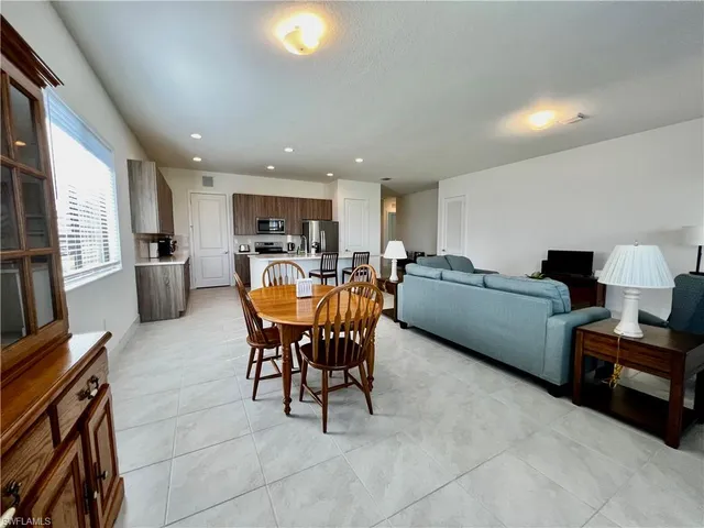 a living room with furniture and a lamp