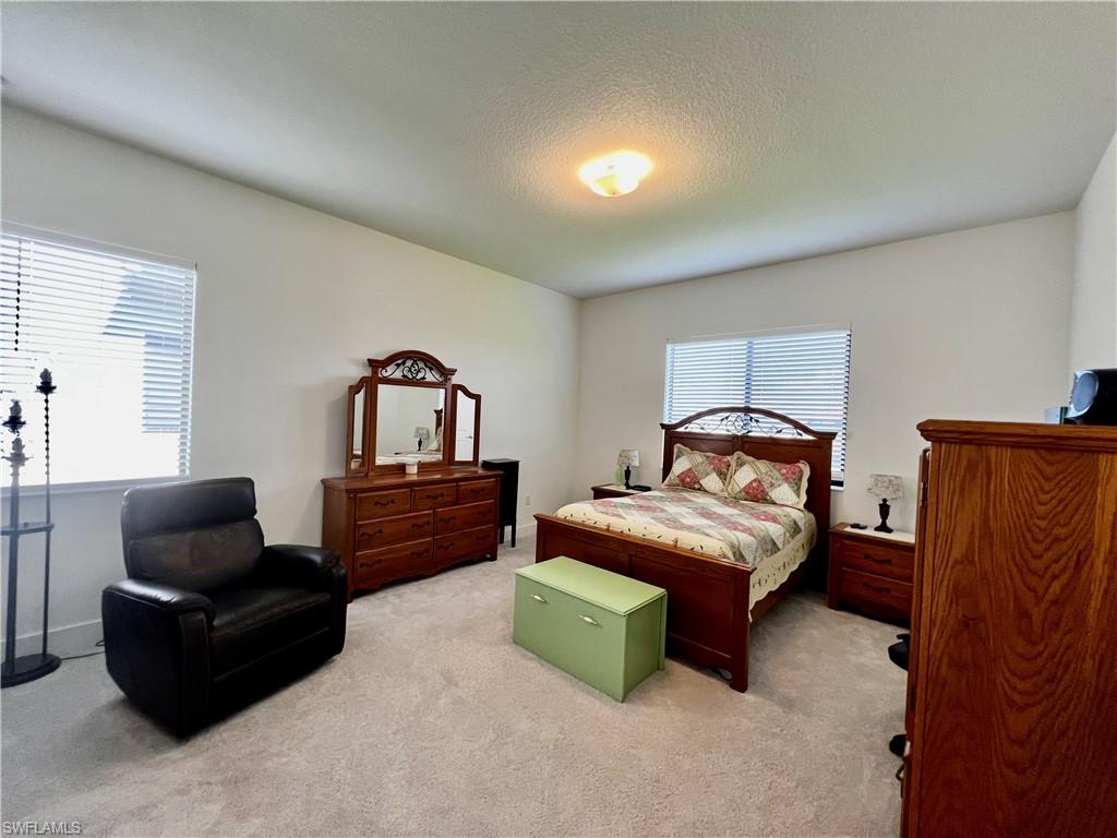 5015 Frattina St Avenue Immokalee, FL 34142 - Photo 6 of 23 a bedroom with furniture and a window