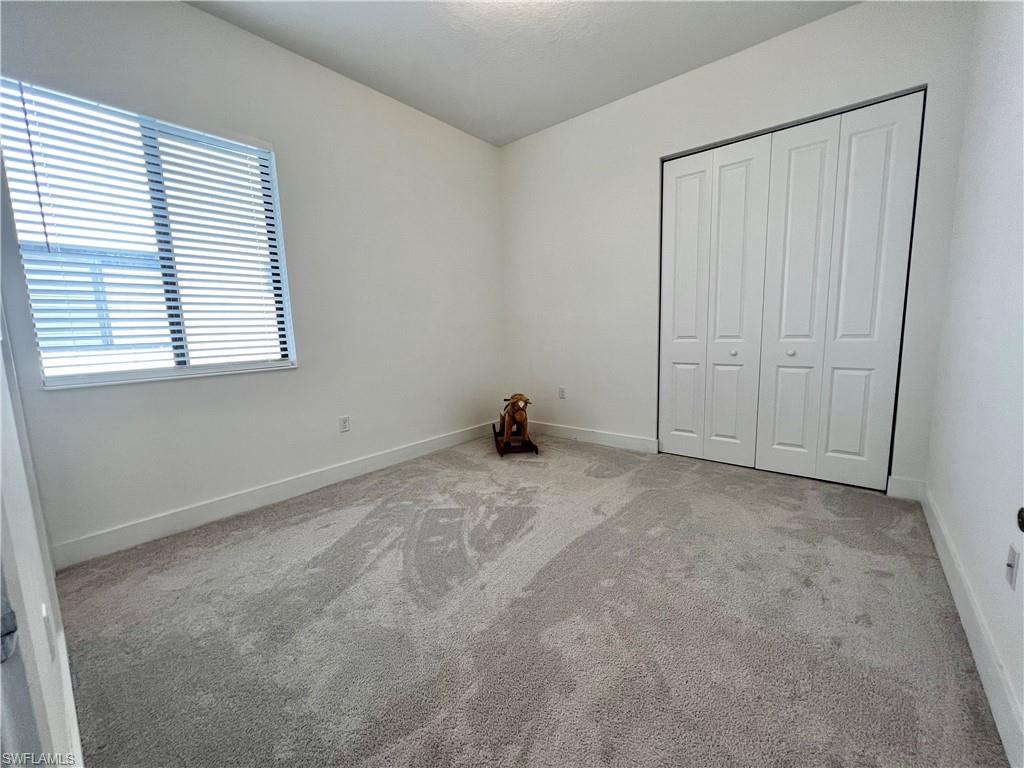 5015 Frattina St Avenue Immokalee, FL 34142 - Photo 7 of 23 a view of an empty room with a window