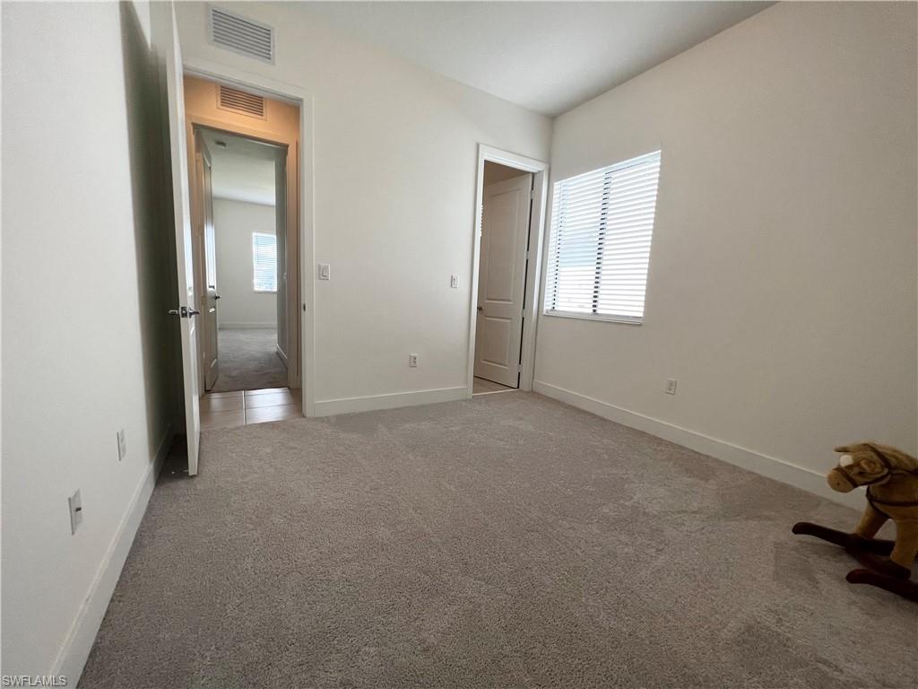 5015 Frattina St Avenue Immokalee, FL 34142 - Photo 8 of 23 an empty room with windows and closet