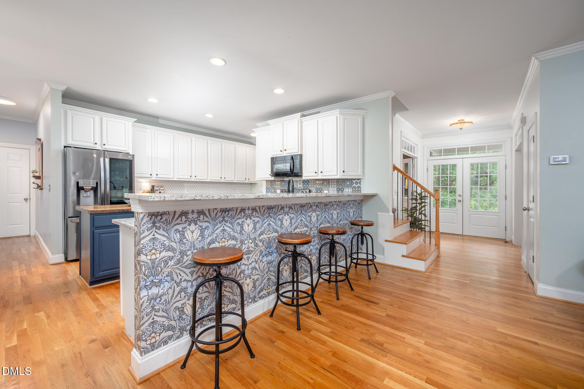 726 Ruth Circle Fuquay-Varina, NC 27526 - Photo 13 of 61 a kitchen with stainless steel appliances granite countertop a stove top oven a refrigerator a dining table and chairs with wooden floor
