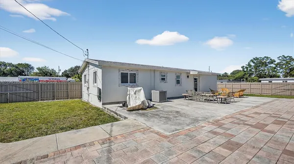 a view of a backyard with sitting area