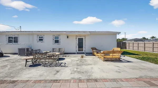 a view of a house with backyard and deck