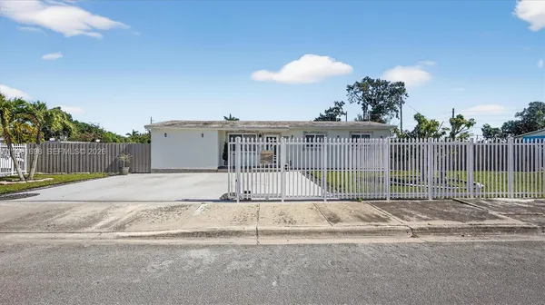 a view of a house with a backyard and a garden