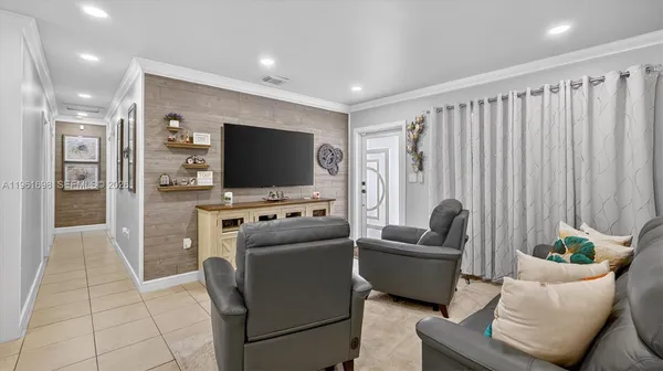 a kitchen with stainless steel appliances granite countertop a refrigerator sink and white cabinets