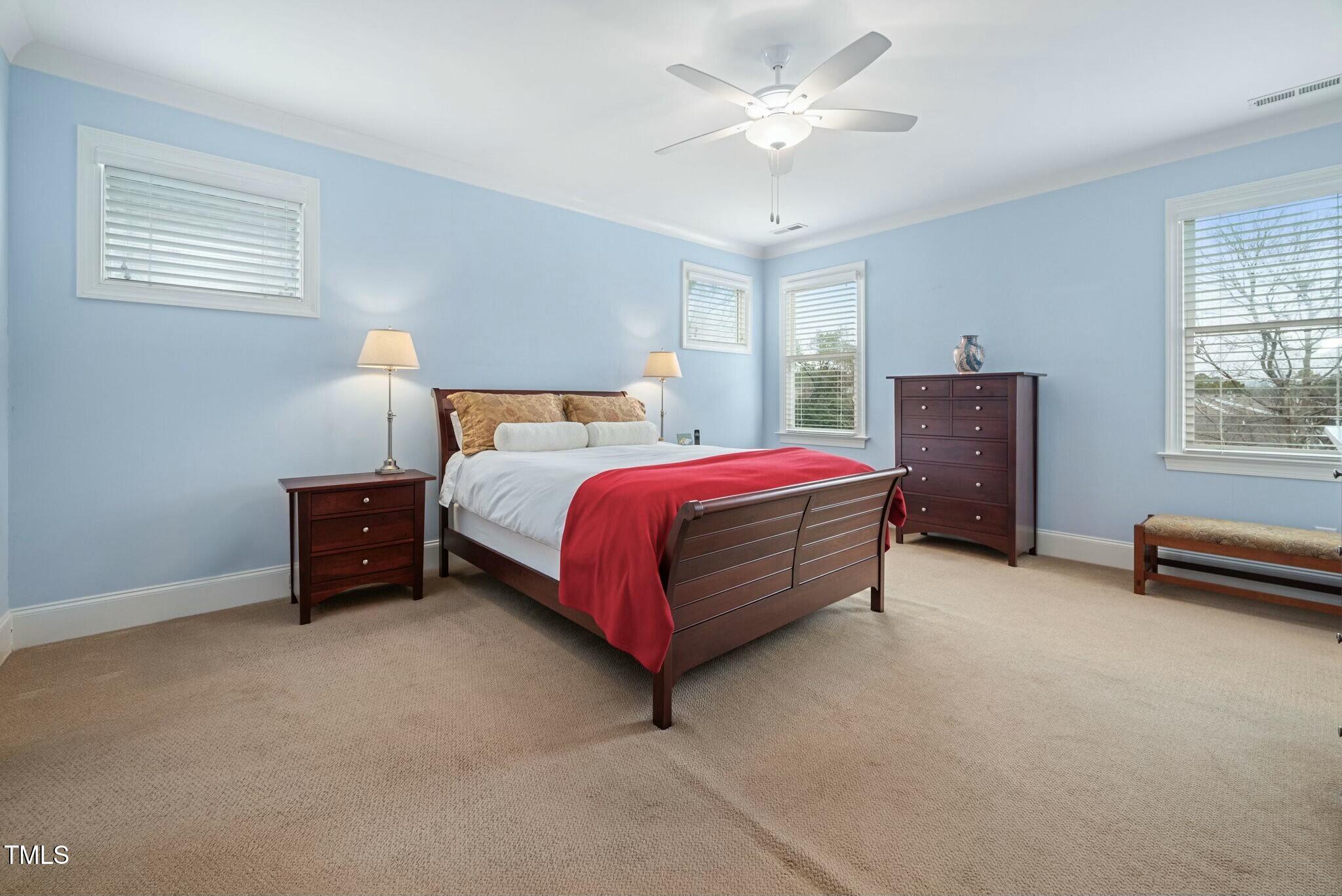 519 Peebles Street Raleigh, NC 27608 - Photo 19 of 43 a bed room with a bed and a ceiling fan