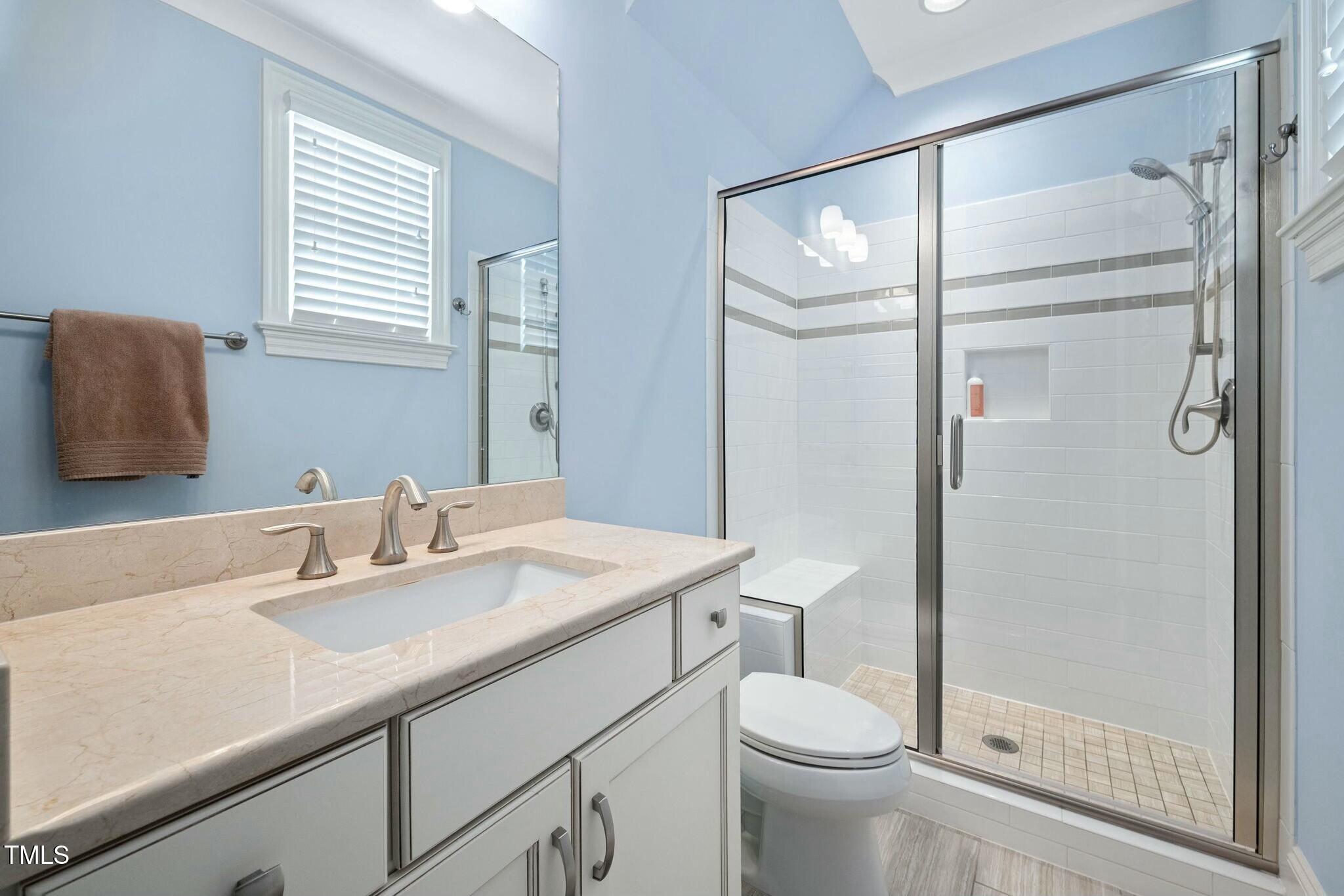 519 Peebles Street Raleigh, NC 27608 - Photo 30 of 43 a bathroom with a sink a toilet and shower